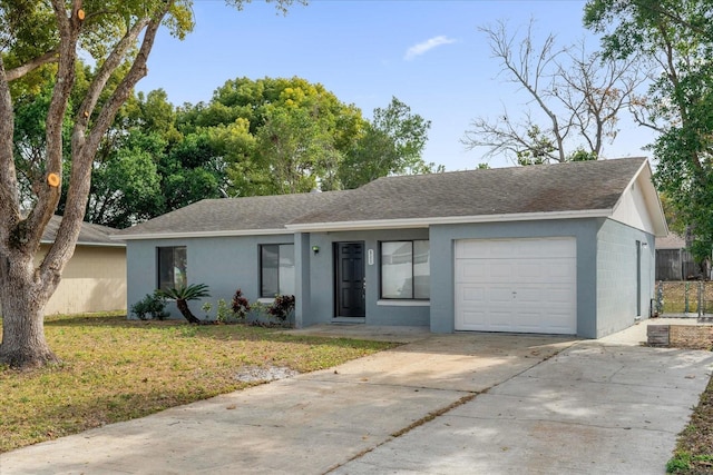 single story home featuring a garage and a front yard