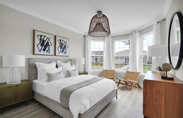 bedroom featuring hardwood / wood-style flooring and ornamental molding