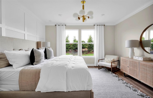 bedroom with dark hardwood / wood-style flooring, ornamental molding, and an inviting chandelier