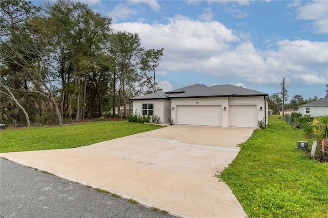 prairie-style home featuring an attached garage, driveway, a front lawn, and stucco siding