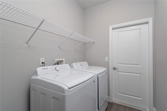 laundry area with laundry area, dark wood-style flooring, and washer and dryer