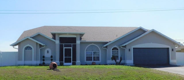 view of front of house with a garage and a front yard