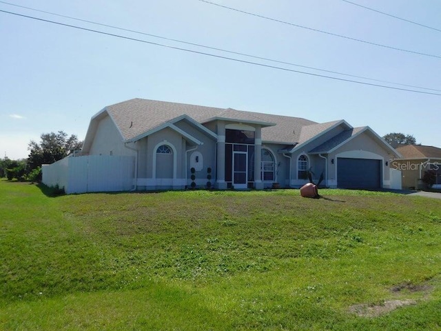 ranch-style house featuring a garage and a front yard