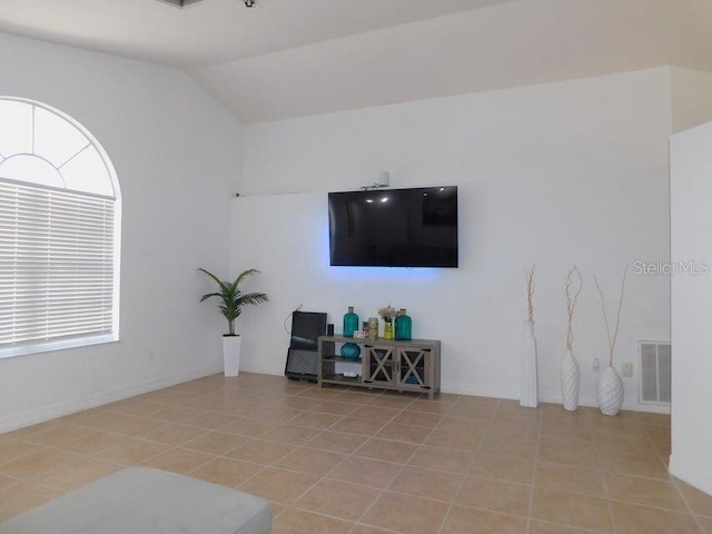 tiled living room with vaulted ceiling