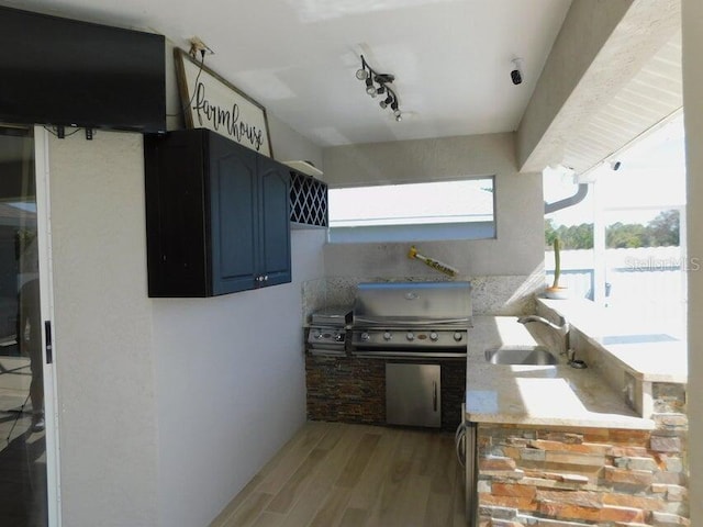 view of patio / terrace featuring an outdoor kitchen, sink, and area for grilling