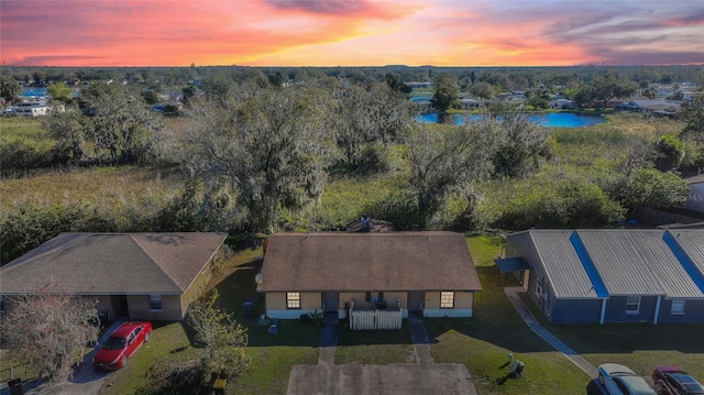 aerial view at dusk with a water view