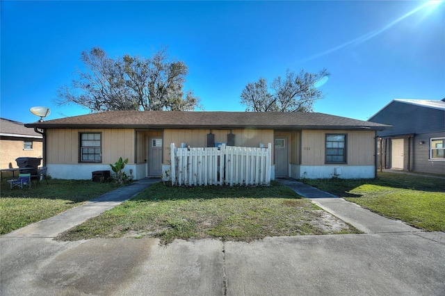 ranch-style home with a front lawn