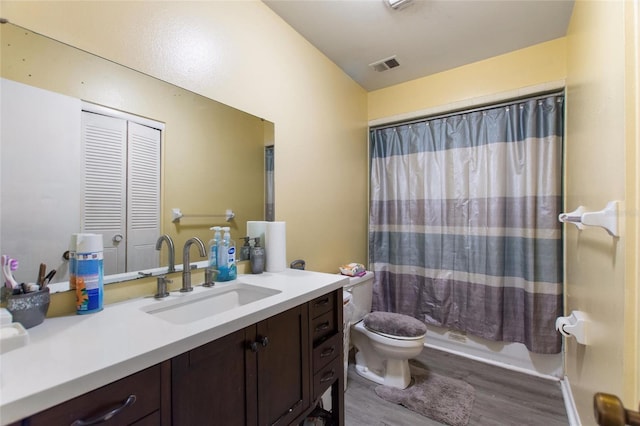 full bathroom with hardwood / wood-style flooring, vanity, toilet, and shower / bath combo with shower curtain