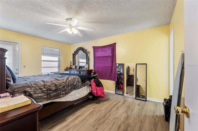 bedroom featuring ceiling fan, a textured ceiling, and light hardwood / wood-style flooring