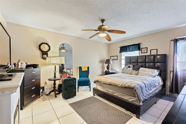 bedroom with light tile patterned floors, a textured ceiling, and ceiling fan