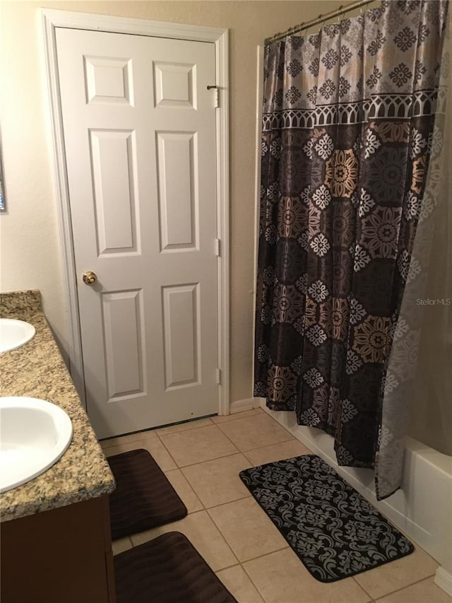 bathroom featuring vanity, tile patterned floors, and shower / bath combo with shower curtain