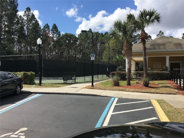 view of parking / parking lot with tennis court