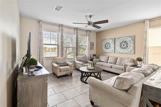 living room with ceiling fan and light tile patterned floors