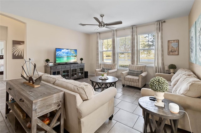 tiled living room with ceiling fan