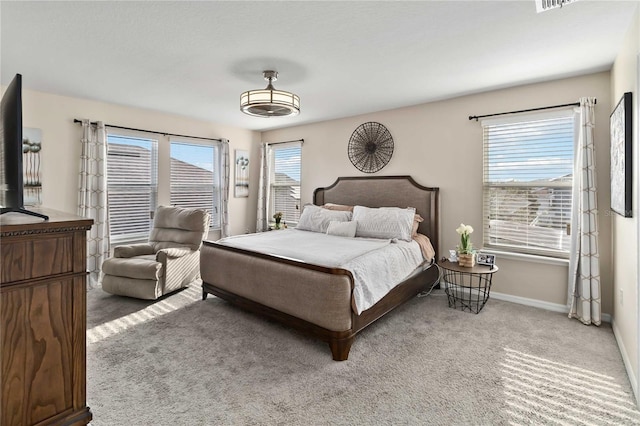 bedroom with carpet flooring and multiple windows