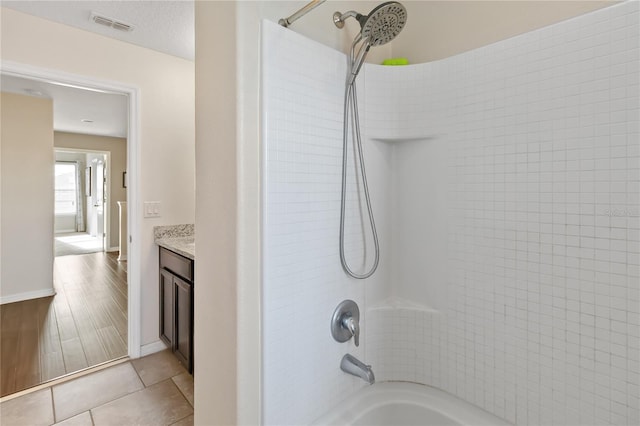 bathroom with tile patterned floors, vanity, and washtub / shower combination