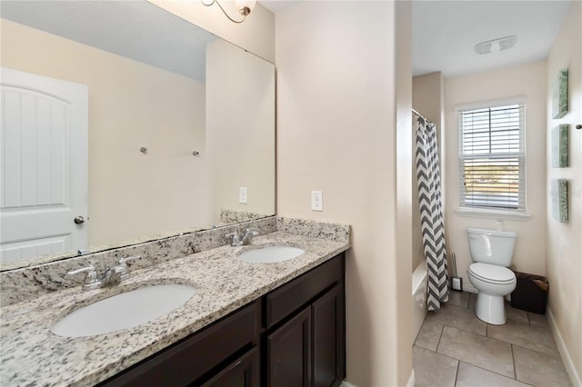 bathroom featuring tile patterned floors, vanity, and toilet