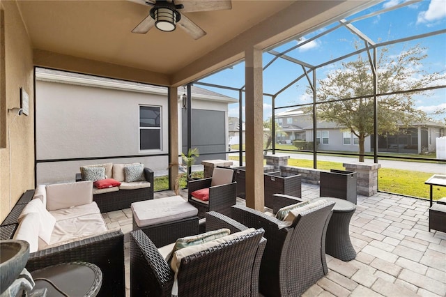 view of patio / terrace with glass enclosure, ceiling fan, and an outdoor living space