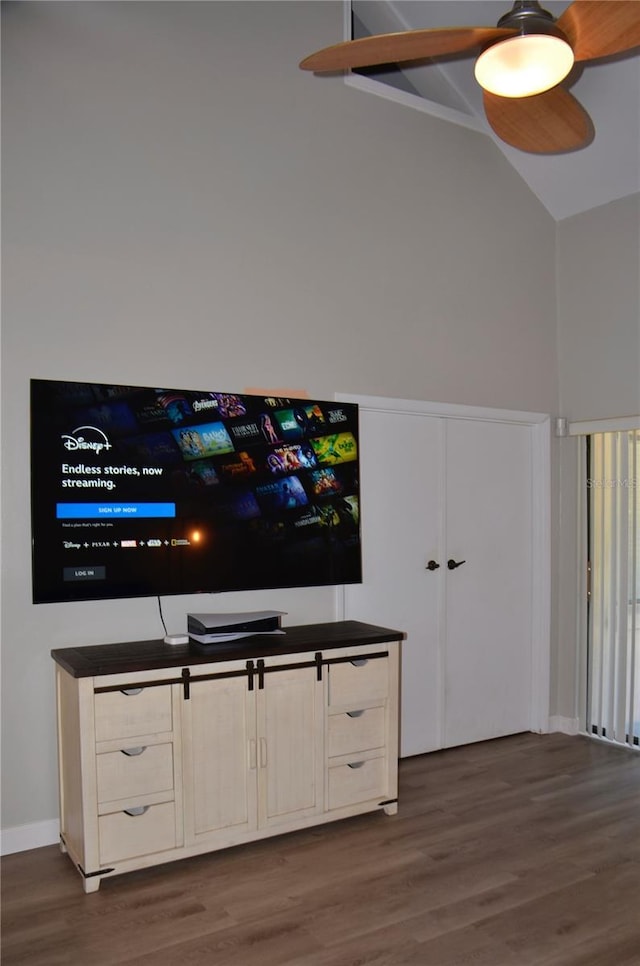 unfurnished living room with dark wood-style flooring and vaulted ceiling