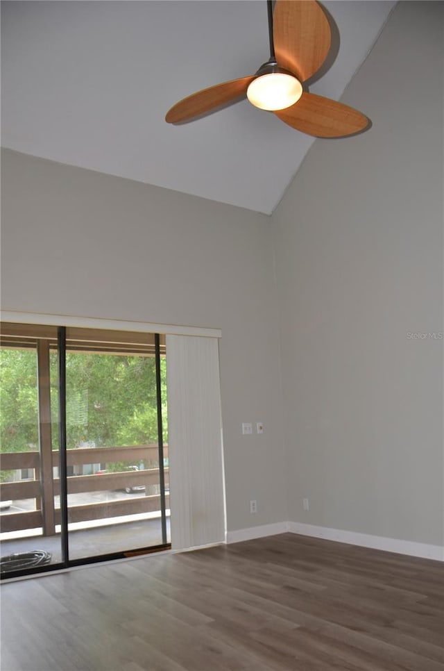 spare room with dark wood-style floors, a high ceiling, baseboards, and a ceiling fan