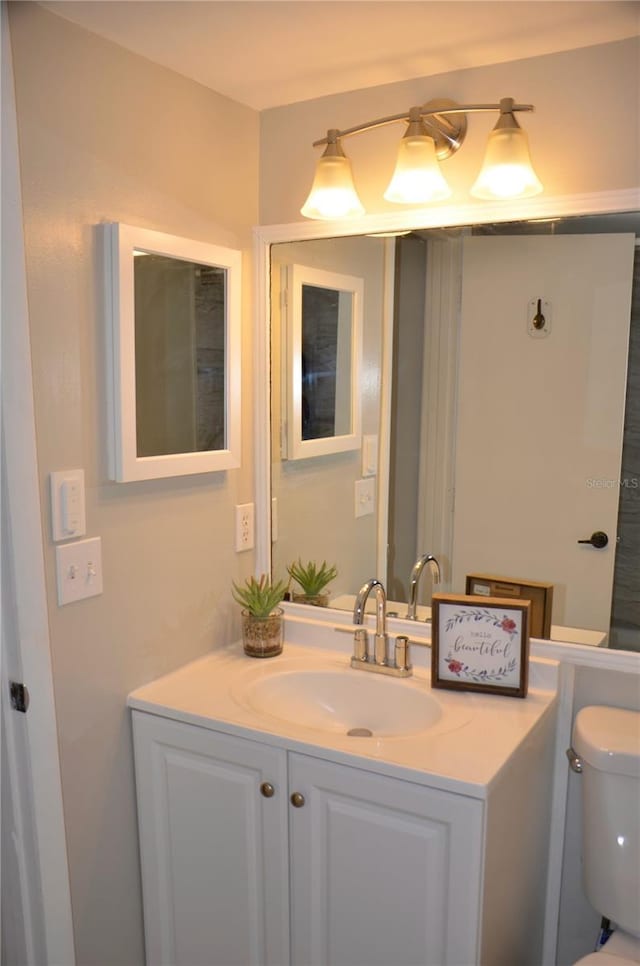 bathroom featuring toilet and vanity