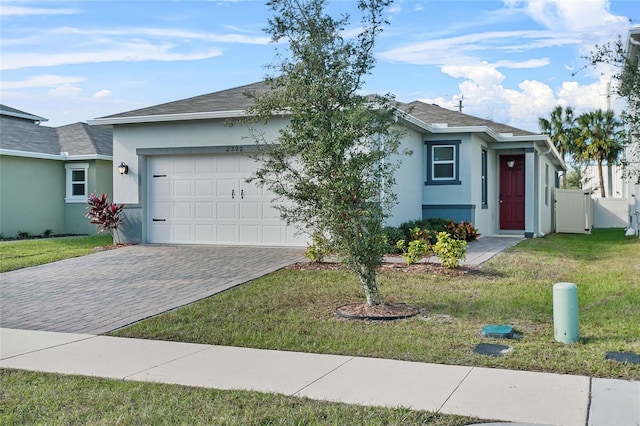 ranch-style home with a front yard and a garage