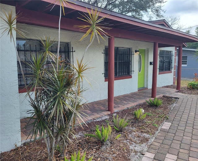 doorway to property featuring covered porch