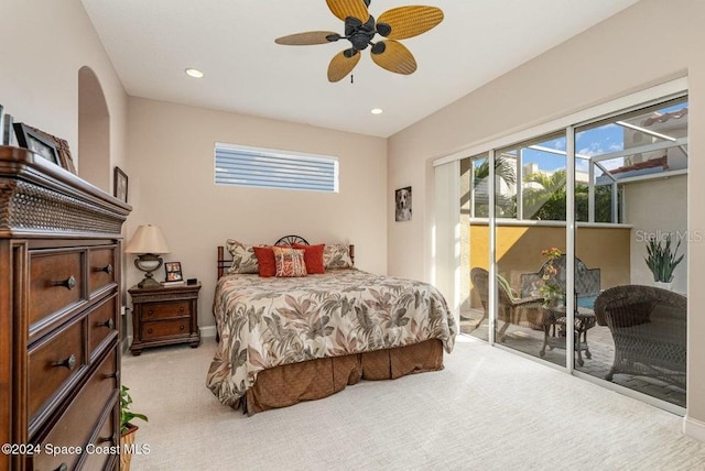 bedroom with access to exterior, ceiling fan, light colored carpet, and multiple windows