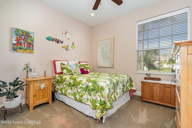 bedroom with ceiling fan and light carpet