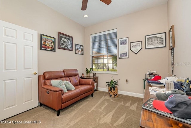 sitting room featuring light colored carpet and ceiling fan