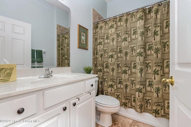 bathroom featuring tile patterned flooring, vanity, and toilet