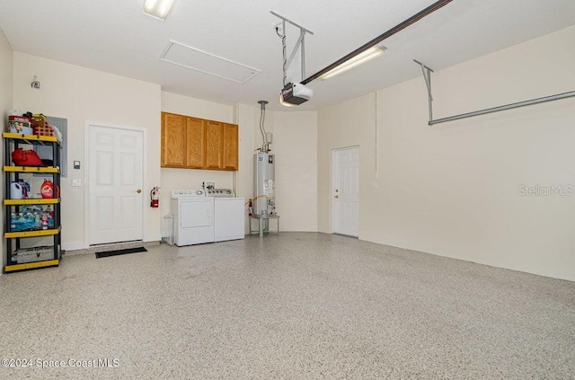 garage featuring separate washer and dryer, water heater, and a garage door opener