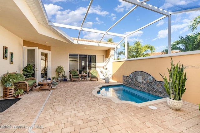 view of swimming pool featuring a lanai and a patio area