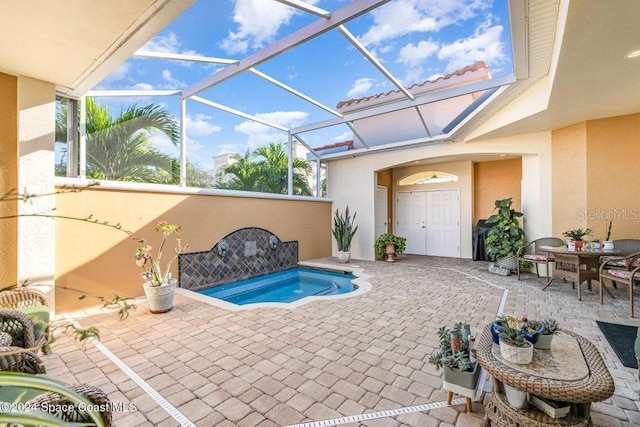 view of swimming pool featuring glass enclosure and a patio area