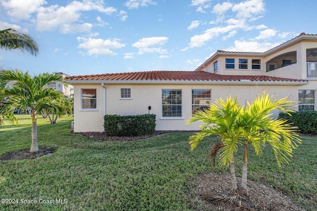 rear view of property featuring a yard