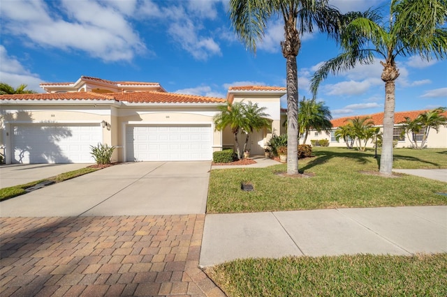 560 Casa Bella Dr Unit 1603, Cape Canaveral, FL 32920 - mediterranean / spanish home featuring driveway, stucco siding, a garage, a front yard, and a tiled roof