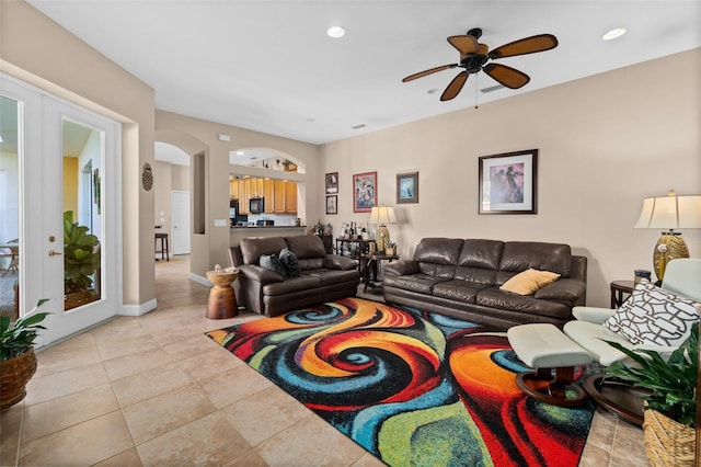 living room with ceiling fan, light tile patterned floors, and french doors