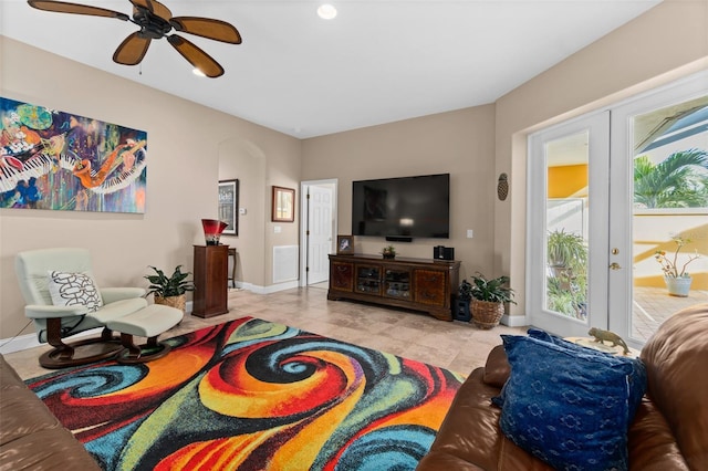 living room featuring plenty of natural light, ceiling fan, and french doors