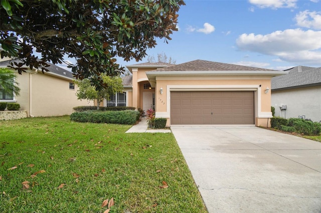 view of front of home featuring a front lawn and a garage