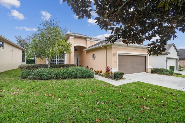 view of front of home with a front yard and a garage