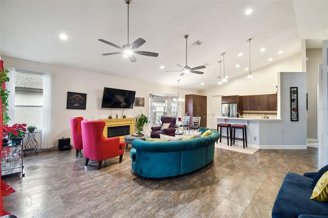 living room with ceiling fan with notable chandelier and high vaulted ceiling