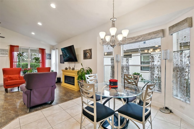 tiled dining room featuring vaulted ceiling and an inviting chandelier