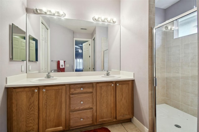 bathroom with tile patterned flooring, vanity, and a shower with shower door