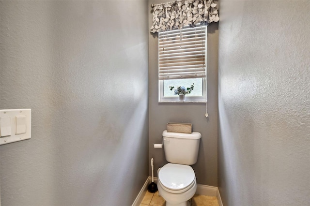 bathroom with tile patterned flooring and toilet