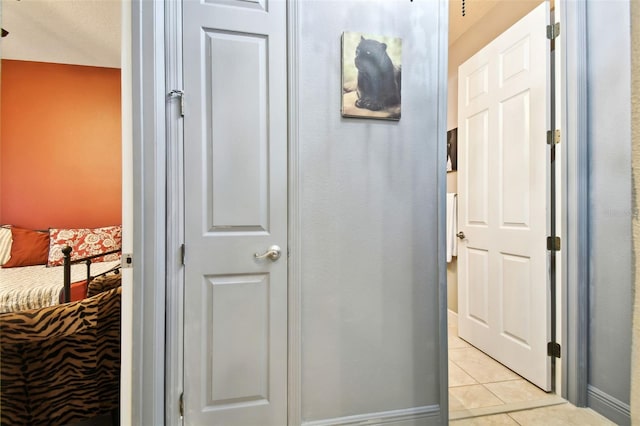 hall with light tile patterned floors