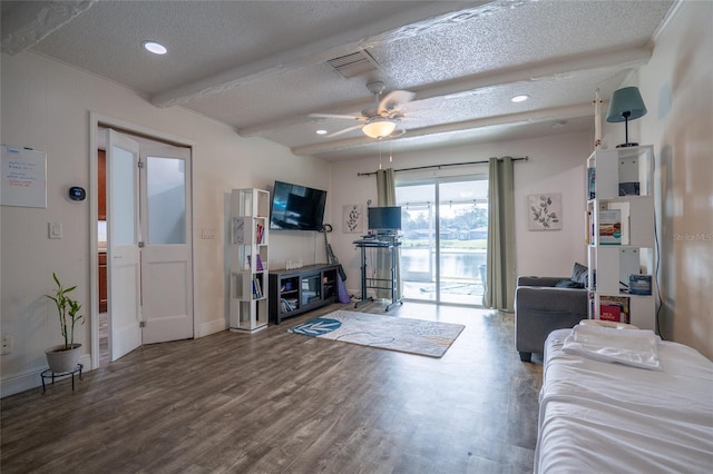 living room with ceiling fan, beam ceiling, wood-type flooring, and a textured ceiling