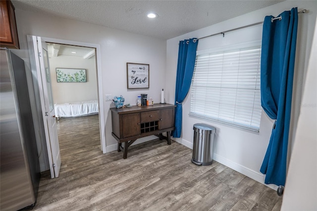 interior space featuring hardwood / wood-style floors and a textured ceiling