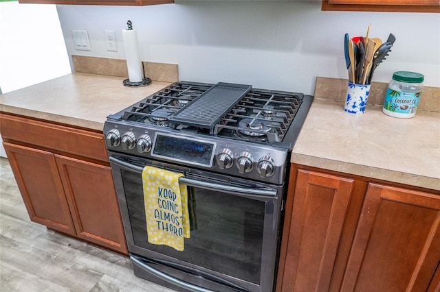 kitchen with light wood-type flooring and stainless steel gas range