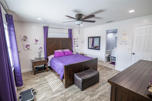 bedroom featuring ceiling fan, light hardwood / wood-style floors, a textured ceiling, and connected bathroom