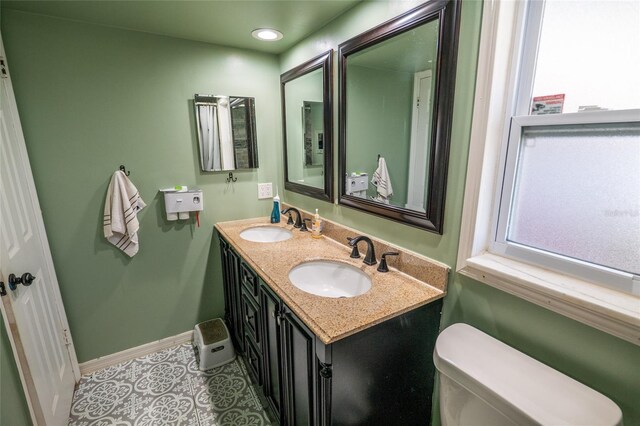 bathroom with tile patterned floors, vanity, and toilet